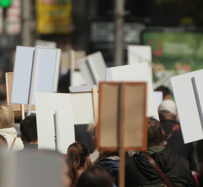 Group of workers on strike holding up signs